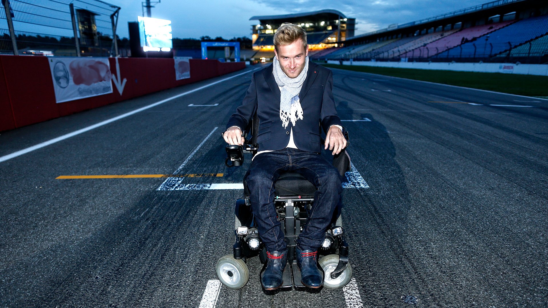 Der Künstler auf einer Rennbahn in einem Rollstuhl