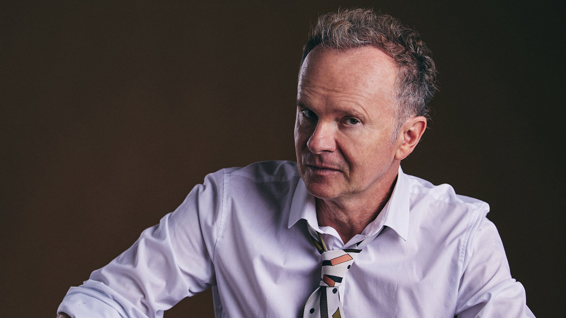 Foto für die Veranstaltung Willy Astor – Reimart und Lachkunde. Prädikat Wortvoll mit dem Künstler vor schwarzem Hintergrund