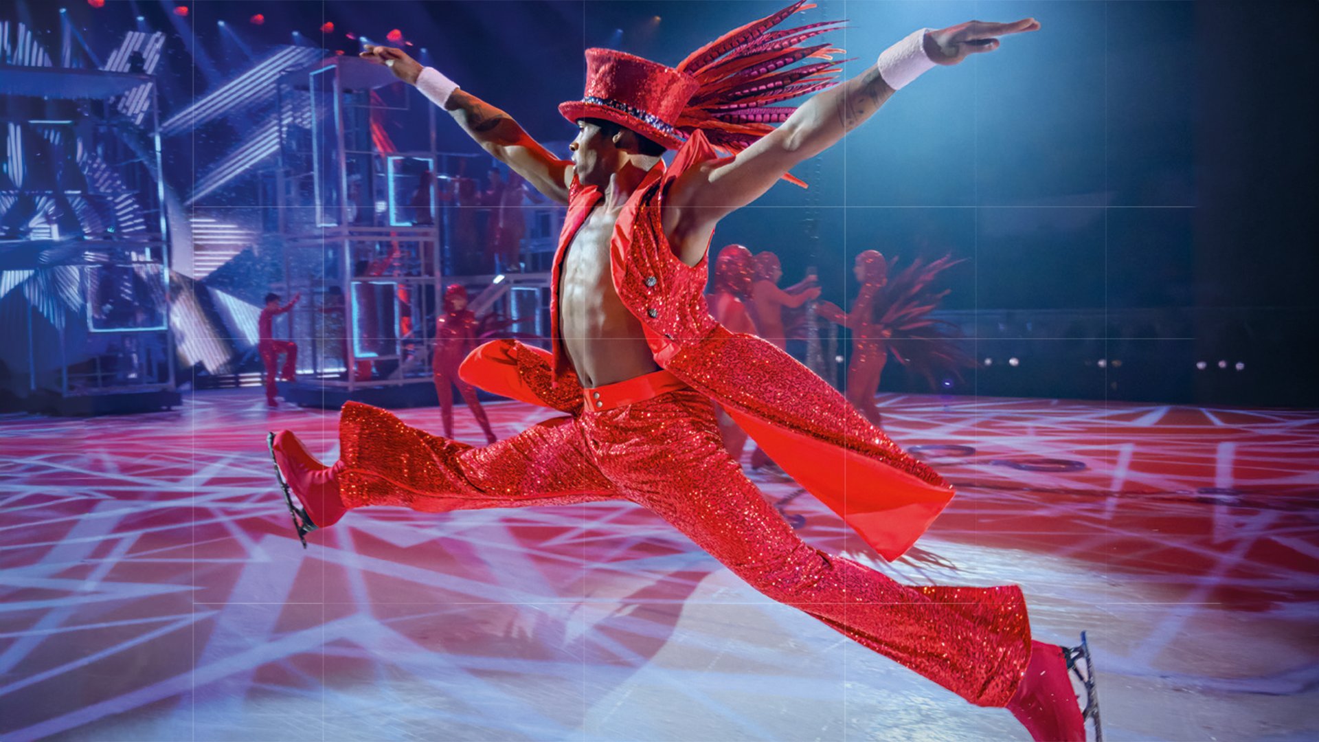 EIn Eistänzer in rotem Kostüm und Hut während eines Sprungs 