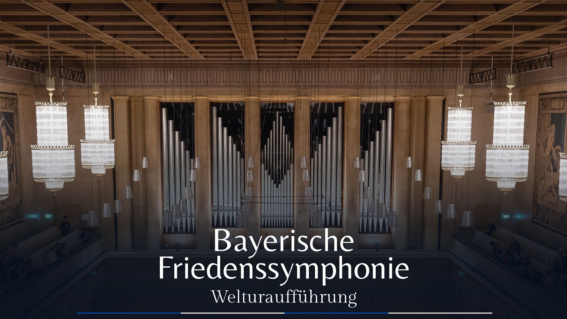 Foto für das Event Sound of Peace mit einem Innenraumfoto eines eleganten Gebäudes, in dem stilvolle, herabhängende Lampen zu sehen sind.