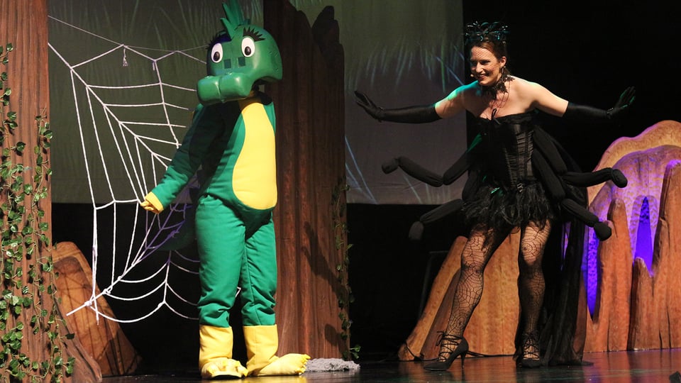 Eine Darstellerin und die Tabaluga-Figur auf der Bühne