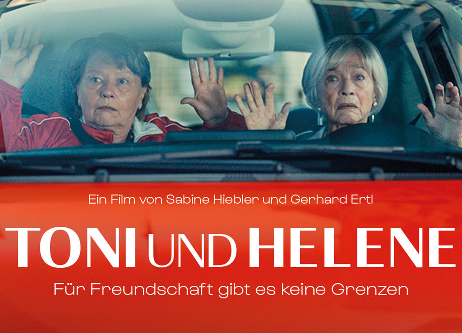 Filmplakat mit zwei Damen in Auto, die Hände hoch streckend
