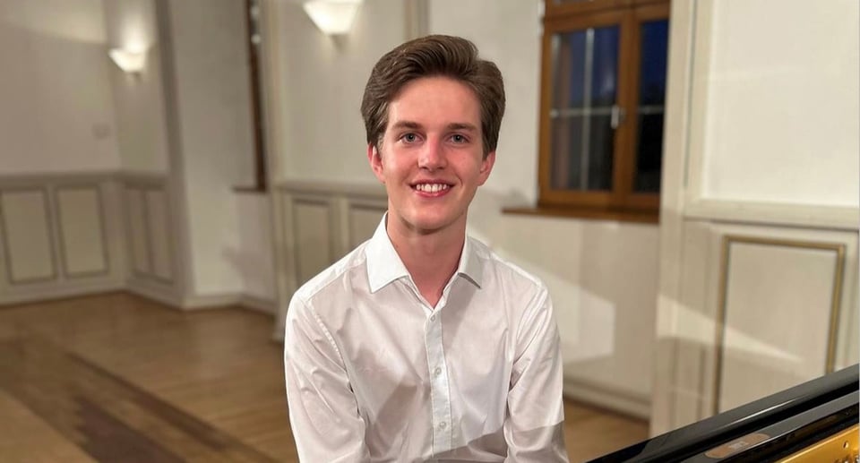 Der junge Künstler in einem Saal sitzend 
