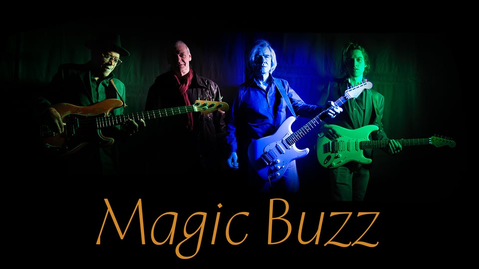 Foto für die Veranstaltung *Magic Buzz* mit den Künstlern, die mit farbigen Lichtern auf schwarzem Hintergrund ausgeleuchtet sind