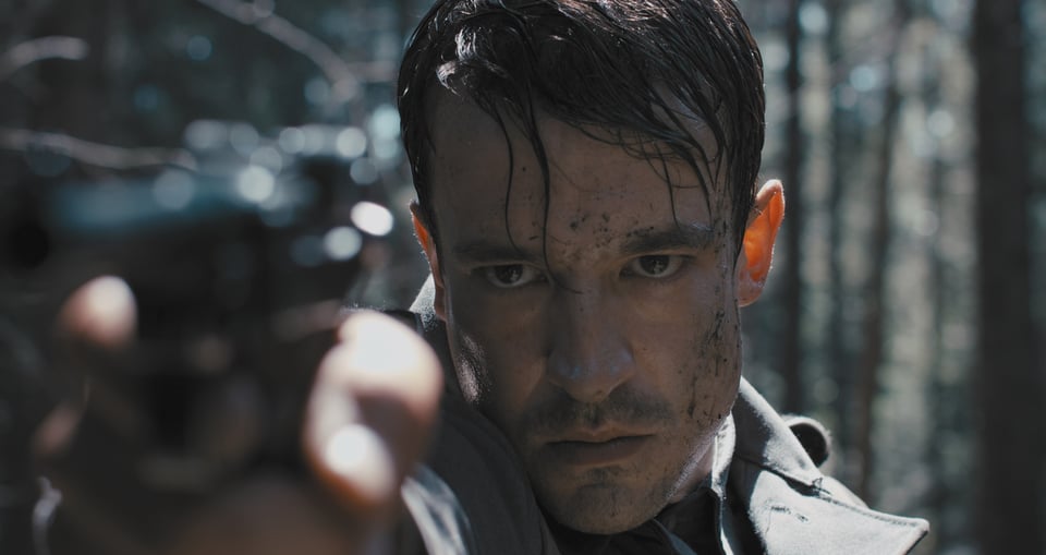 Foto für die Veranstaltung des Films ‚Der Deserteur‘ mit einem Mann, der mit einer Pistole zielt