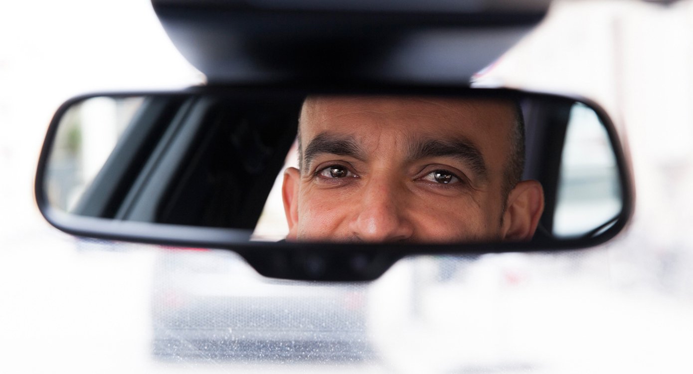 die Augen des Künstlers, die sich im Rückspiegel eines Autos spiegeln