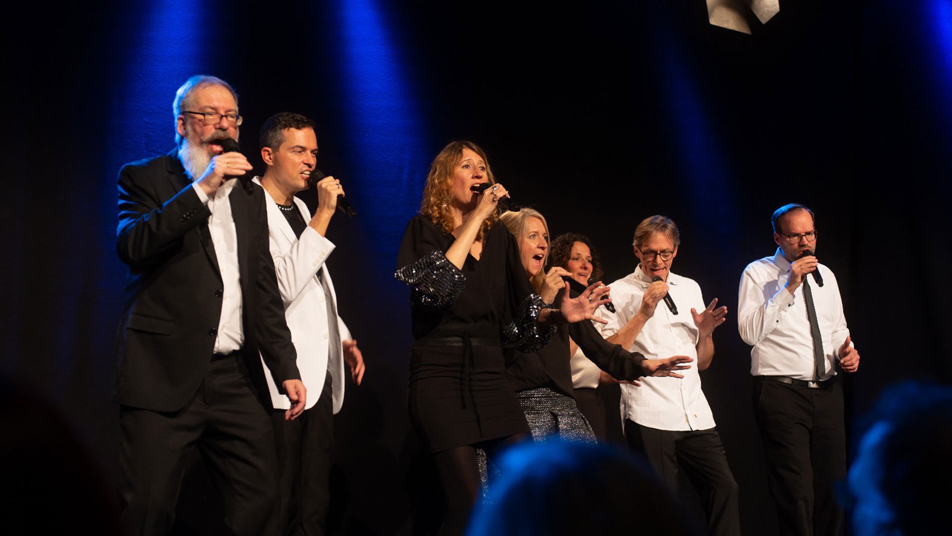 Foto für das Event bar nineteen: HUMAN, mit den Künstlerinnen und Künstlern, die auf einer Bühne singen