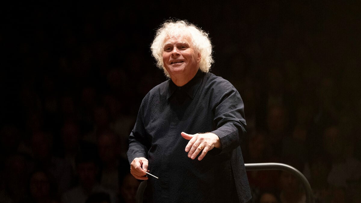 Sir Simon Rattle auf der Bühne mit Dirigentenstock