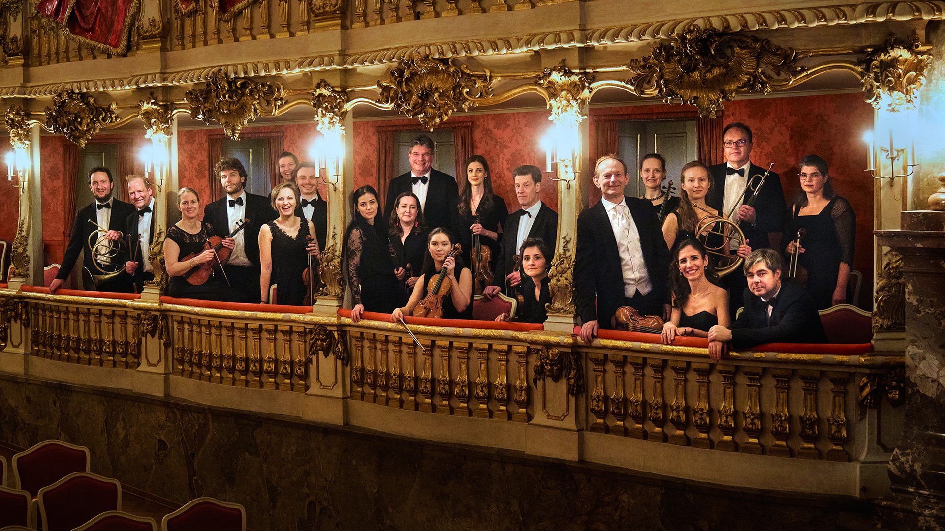 Das Orchester steht auf Balkonen eines festlichen Saals