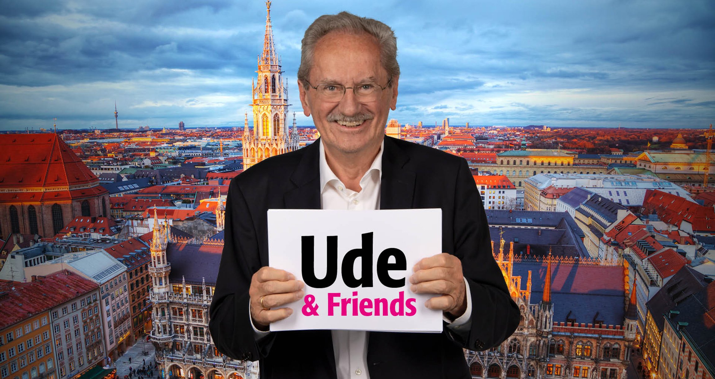 Mann mit Schild in der Hand vor Bild von München im Hintergrund