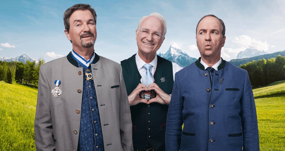 3 Männer vor Alpen Hintergrund